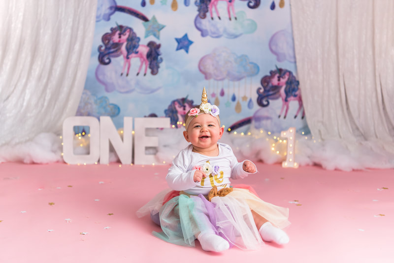 Baby smiling for first birthday photos