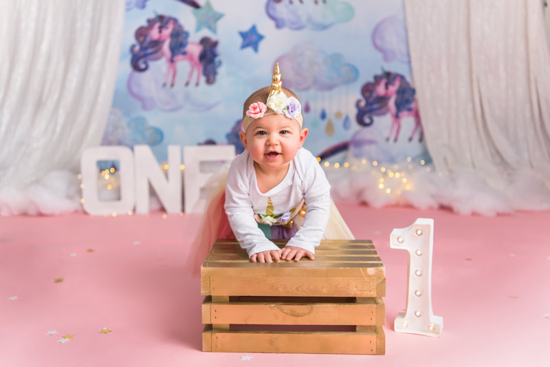 Baby posing for unicorn first birthday photos