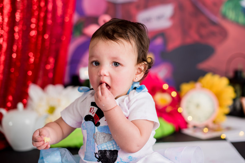 Baby eating cake for first birthday session