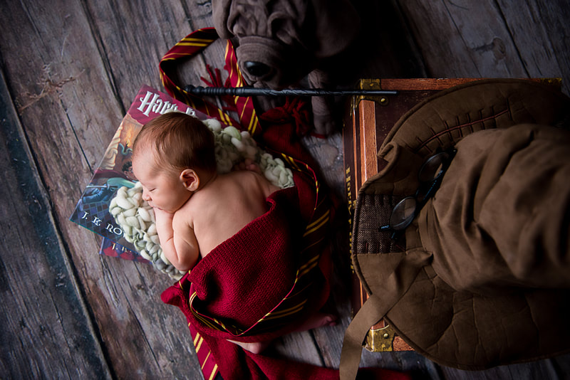 Pittsburgh newborn photographer- Harry Potter baby with wand in newborn studio session at Lovely Day Pittsburgh