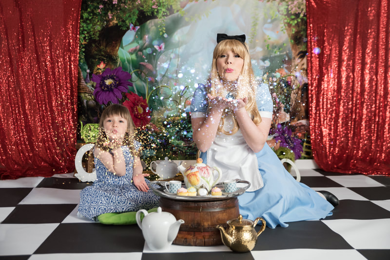 Alice and girl having tea party in Wonderland