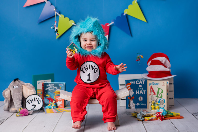 Child dressed like Thing 1 for Dr. seuss themed photos