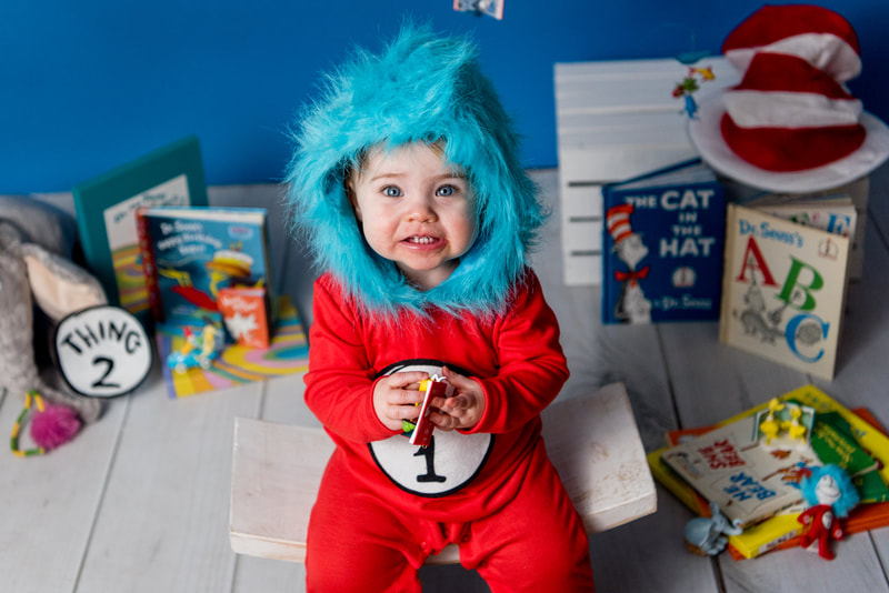 Child dressed like Thing 1 smiles