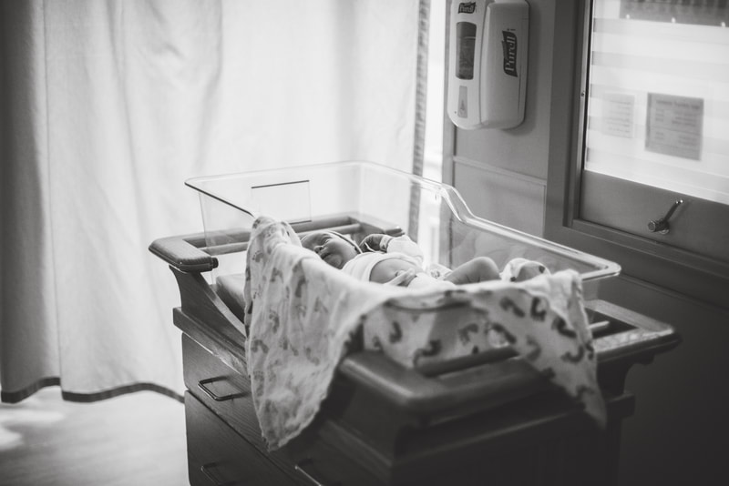 Baby in a bassinet after birth in the hospital