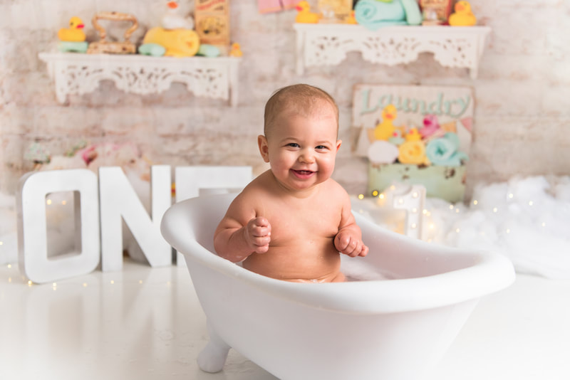 Baby smiling in bubble bath